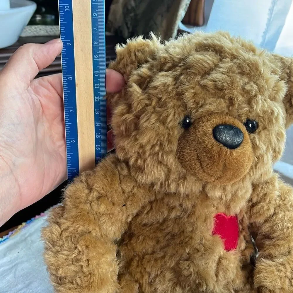 10” DGE plush curly haired Teddy bear with red heart.